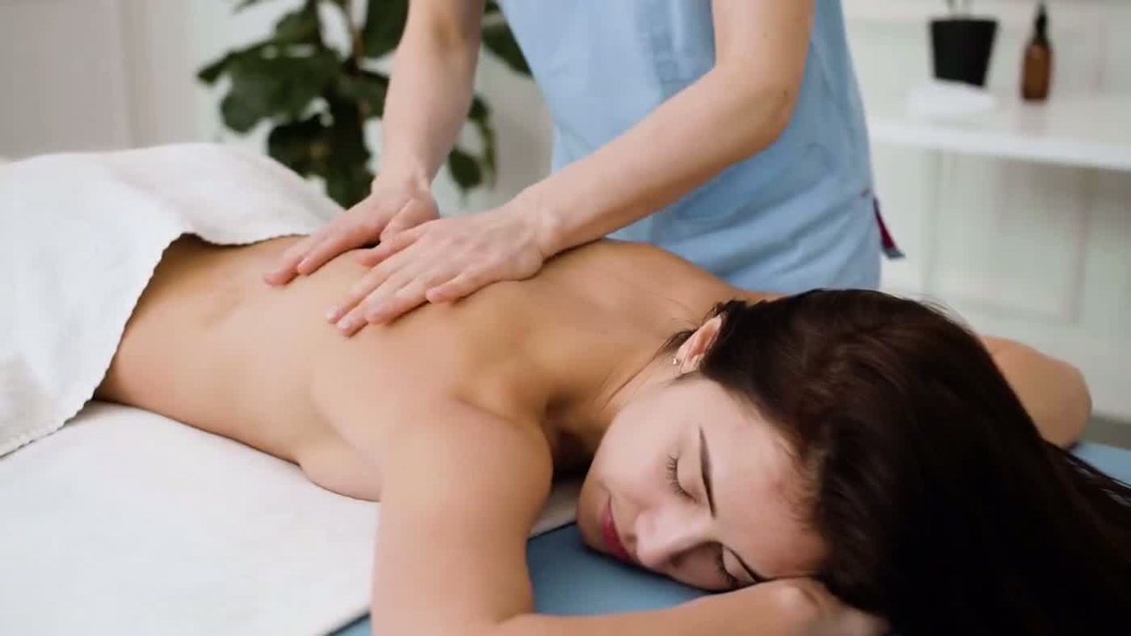 A therapist providing a calm in-home massage in Vancouver.